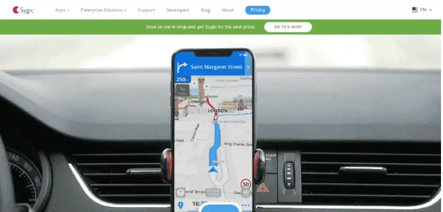 A smartphone on a car holder showing Sygic interface of a destination from place A to B.