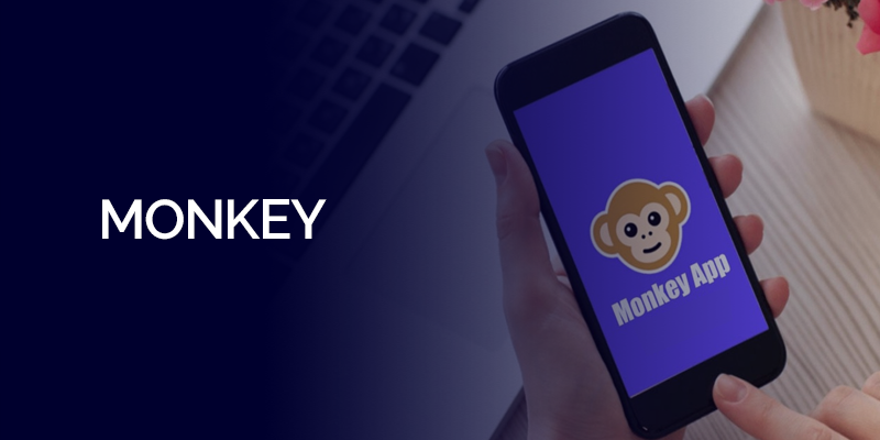 Person holding a smartphone displaying the Monkey App logo.